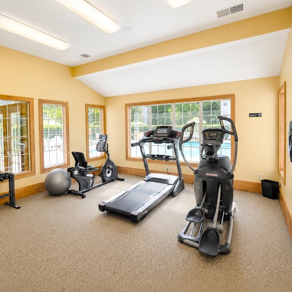 A spacious home gym with a variety of exercise equipment.