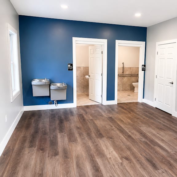 A room with blue walls and wooden floors.