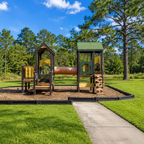 A playground with a slide and a wooden structure.