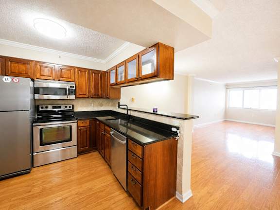 A kitchen with wooden cabinets and stainless steel appliances.