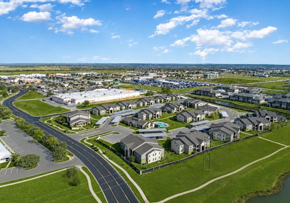 A suburban neighborhood with houses and a winding road.