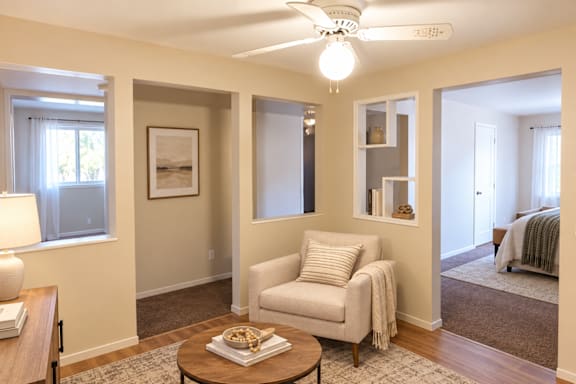 A living room with a white chair and a coffee table.