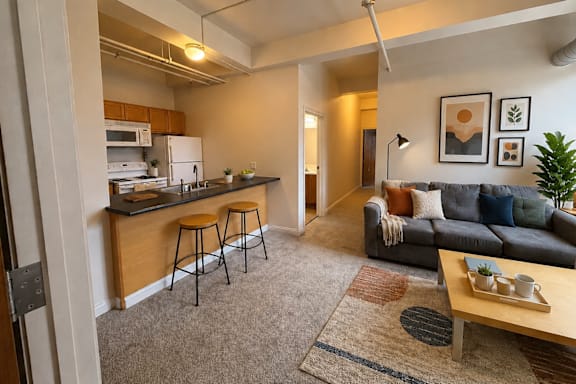 A living room with a grey couch and a wooden coffee table.