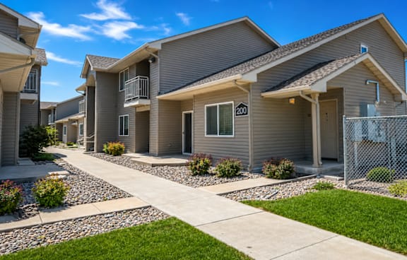 A row of houses with a clear blue sky above them.