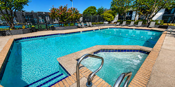 A swimming pool with a metal ladder and steps.