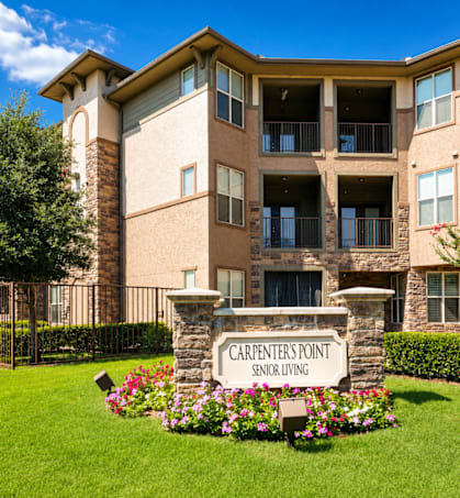 A building with a sign that says Carpenters Point Senior Living.