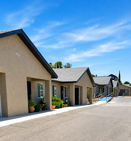 A row of houses with a hill in the background.