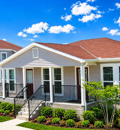 A house with a red roof and a white front porch.