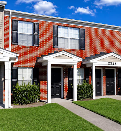 A red brick building with the number 2328 on the front door.