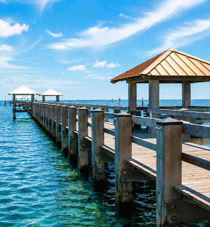 A wooden pier with a gazebo extends into the water.