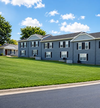 A row of houses with a road in front.