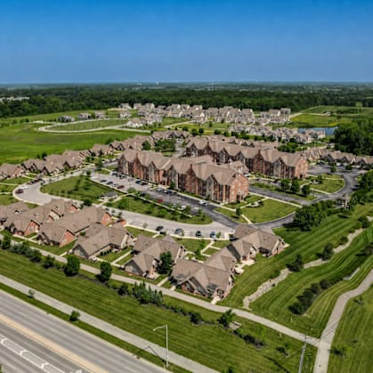 A suburban neighborhood with houses and a road.