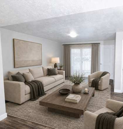 A living room with a couch, armchairs, and a coffee table.