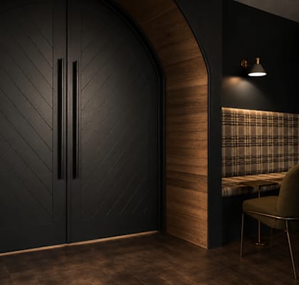A black door with a diamond pattern on the wall.