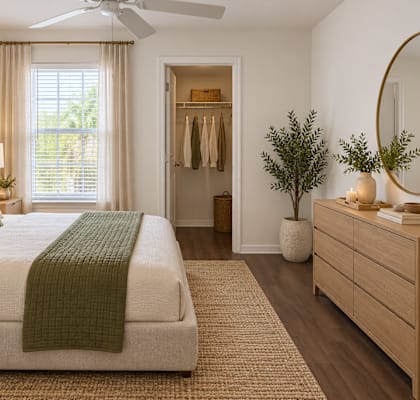 A bedroom with a bed, dresser, and mirror.