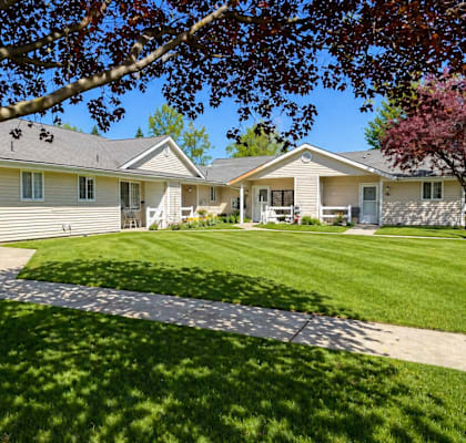 A tree is in front of a house.
