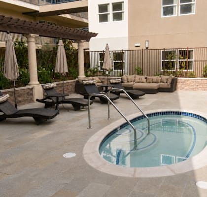 A small round pool with a ladder in the middle of it.