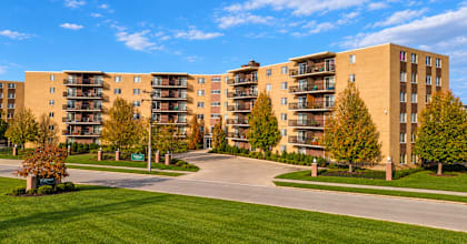 Apartment complex with a green lawn in front.