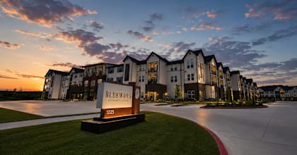 The Bluewood entrance sign at sunset in Kerrville Texas
