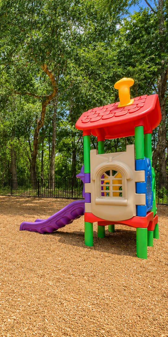 A playground with a slide, swings, and a climbing frame.