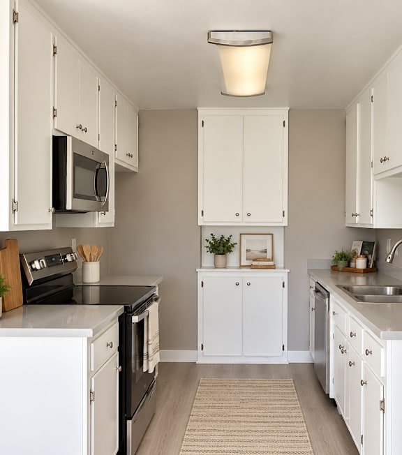 A well-lit, modern kitchen and living room with a dining area.