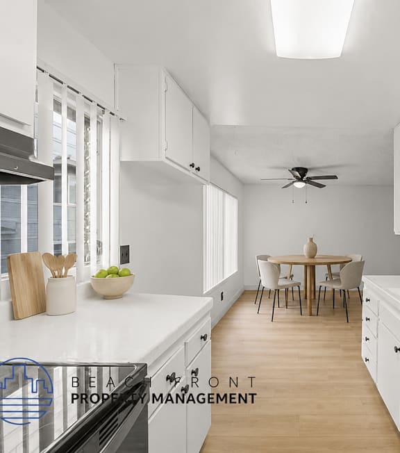 A well-lit, modern kitchen and living room with a dining area.