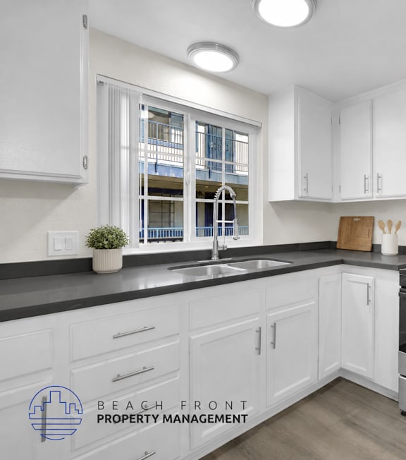 A well-lit, modern kitchen and living room with a dining area.