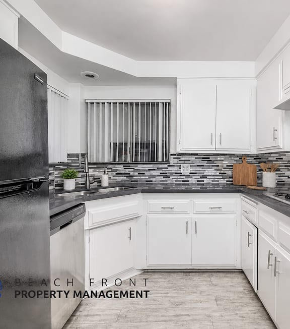 A well-lit, modern kitchen and living room with a dining area.