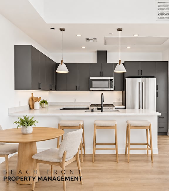A well-lit, modern kitchen and living room with a dining area.