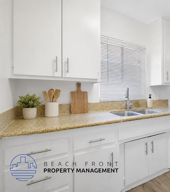 A well-lit, modern kitchen and living room with a dining area.