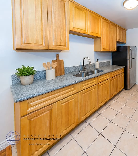 A well-lit, modern kitchen and living room with a dining area.