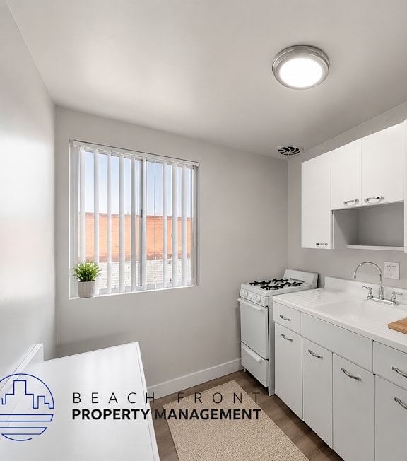 A well-lit, modern kitchen and living room with a dining area.
