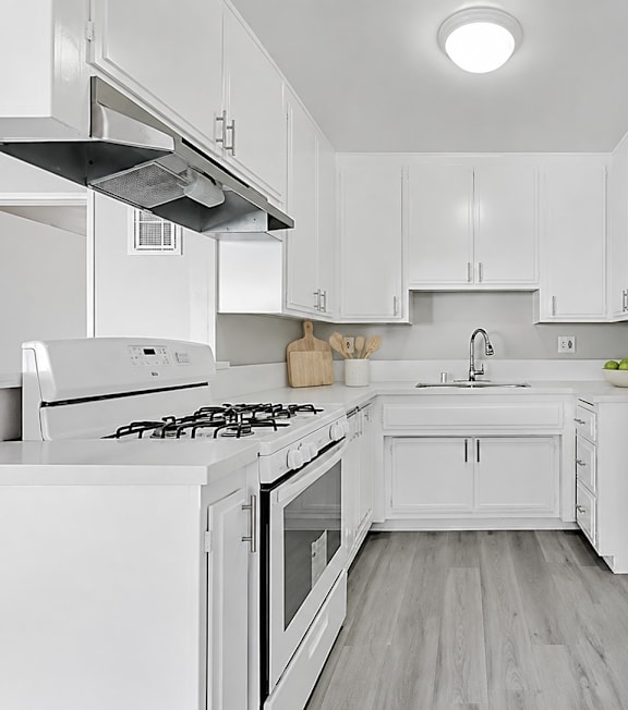 A well-lit, modern kitchen and living room with a dining area.