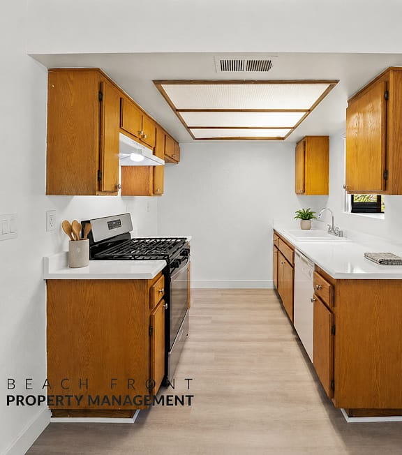 A well-lit, modern kitchen and living room with a dining area.