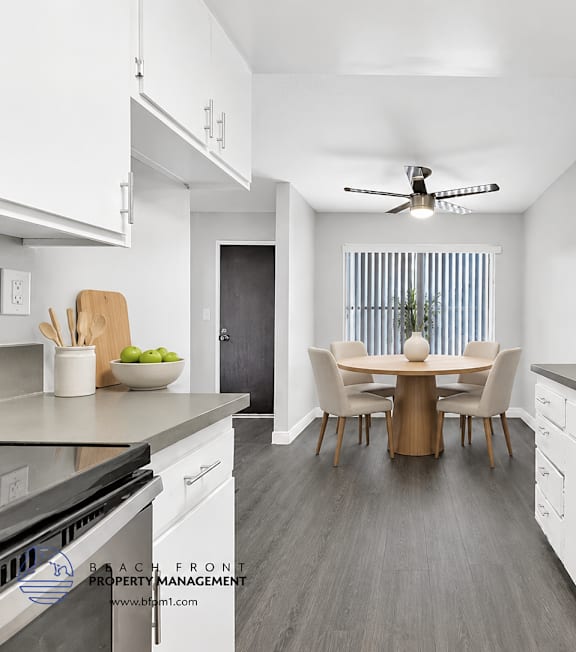 A well-lit, modern kitchen and living room with a dining area.