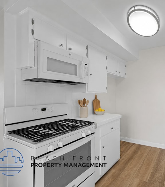 A well-lit, modern kitchen and living room with a dining area.