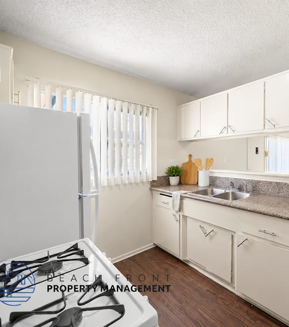 A well-lit, modern kitchen and living room with a dining area.