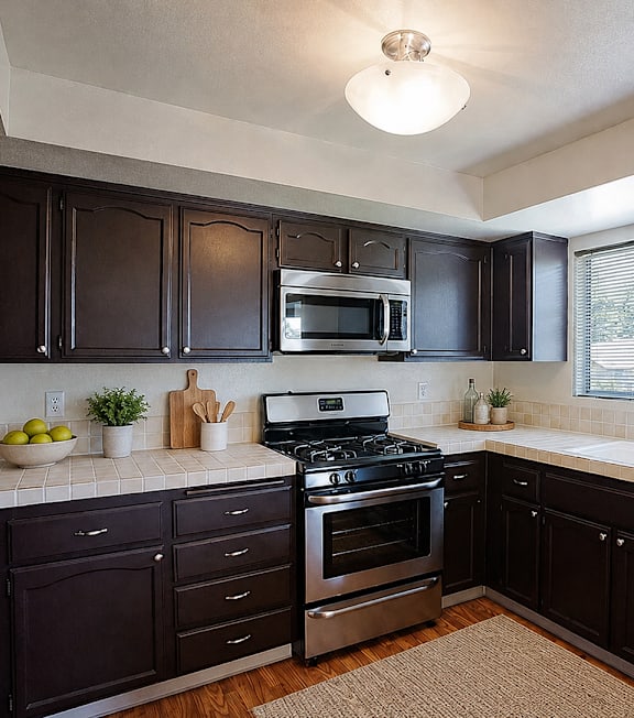 A well-lit, modern kitchen and living room with a dining area.