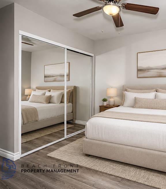 A well-lit bedroom with a large bed and a painting on the wall.