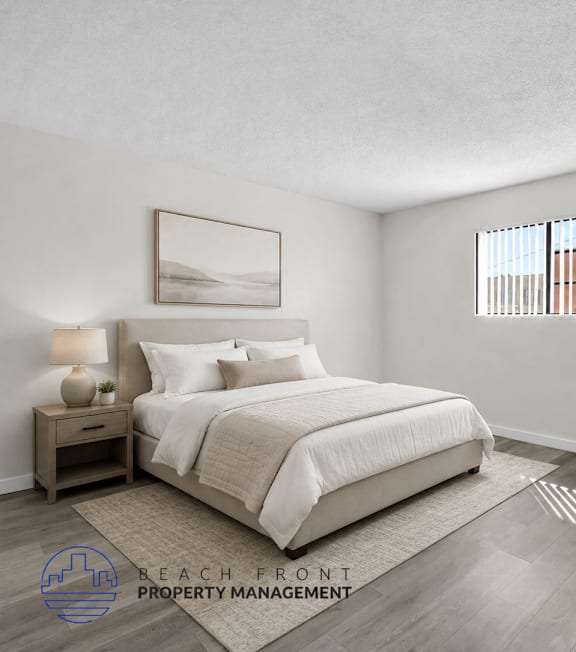 A well-lit bedroom with a large bed and a painting on the wall.