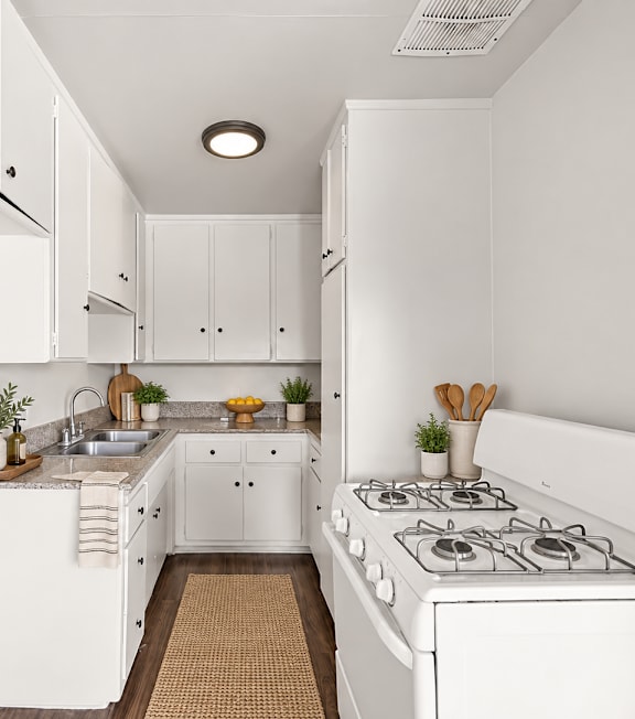 A well-lit, modern kitchen and living room with a dining area.