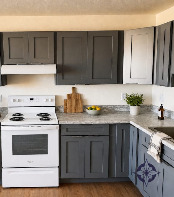 A white stove top oven with a pot on it.
