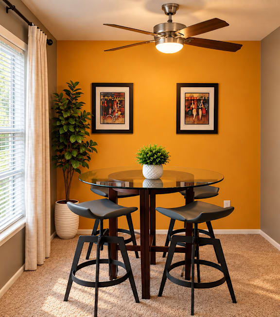 A dining room with a table and chairs.