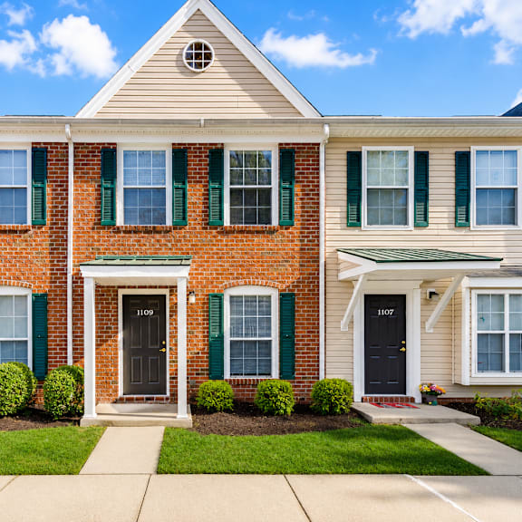 A two-story house with a brick facade and white trim.