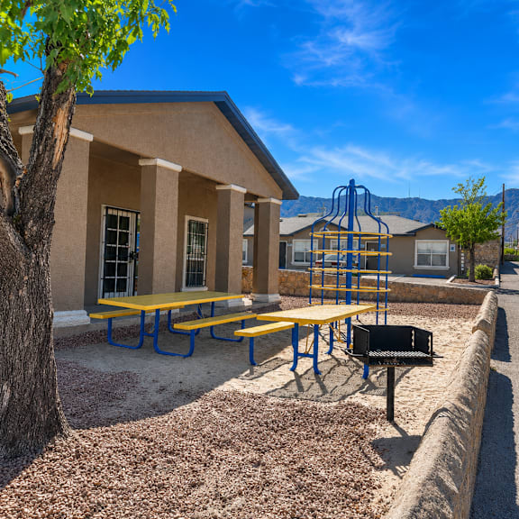 A small building with a playground in front of it.