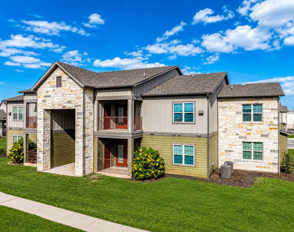 A large two-story house with a stone facade and a garage.