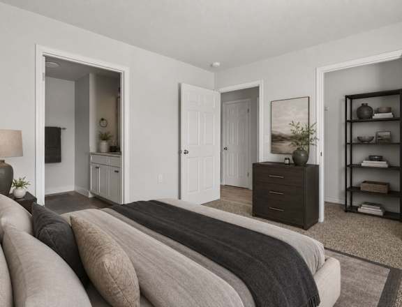 A bedroom with a large bed and a shelf with decorative items.