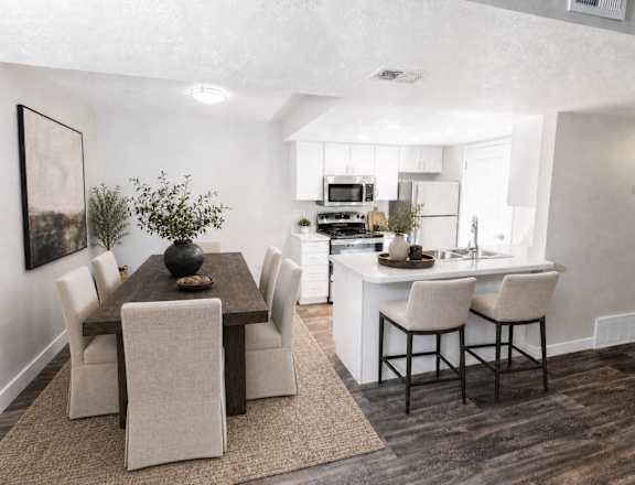 A modern dining room with a wooden table and chairs.