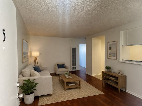 A living room with a couch, chair, and coffee table.