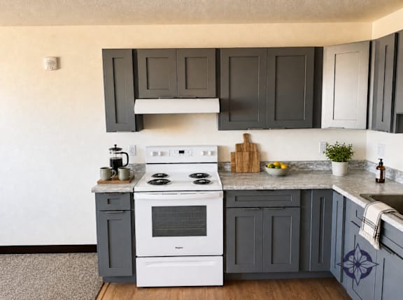 A white stove top oven with a pot on it.